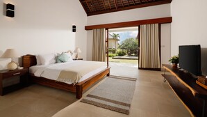 A bedroom with a wooden bed, nightstands, a TV, and a view of the outdoors. - Omegia Canggu by Nakula (Canggu)