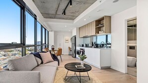 A modern apartment with a living area, dining space, and kitchen. - NEW! Stature Style Southbank! (Southbank)