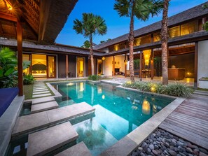 A modern resort with a swimming pool, wooden deck, and tropical plants. - Bumbak Park by Nakula (Kerobokan)