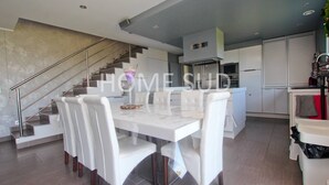 A modern kitchen with white cabinetry, a built-in oven, and a stainless steel range hood. - Modern 4 bedroom villa with jacuzzi  et  private pool - 25 km from Cannes (SPERACEDES)