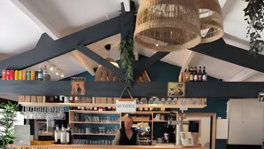 A bistro with a wooden counter, hanging wicker chandeliers, and shelves with bottles and glasses. - Mobile Home "Le Marie Elodie 85" with 2 Shared Pools, Private Terrace & Wi-Fi (Angles)