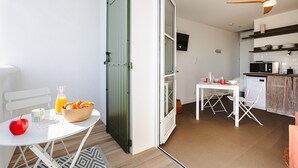 Une cuisine moderne avec des meubles blancs, un four à micro-ondes et une machine à café.