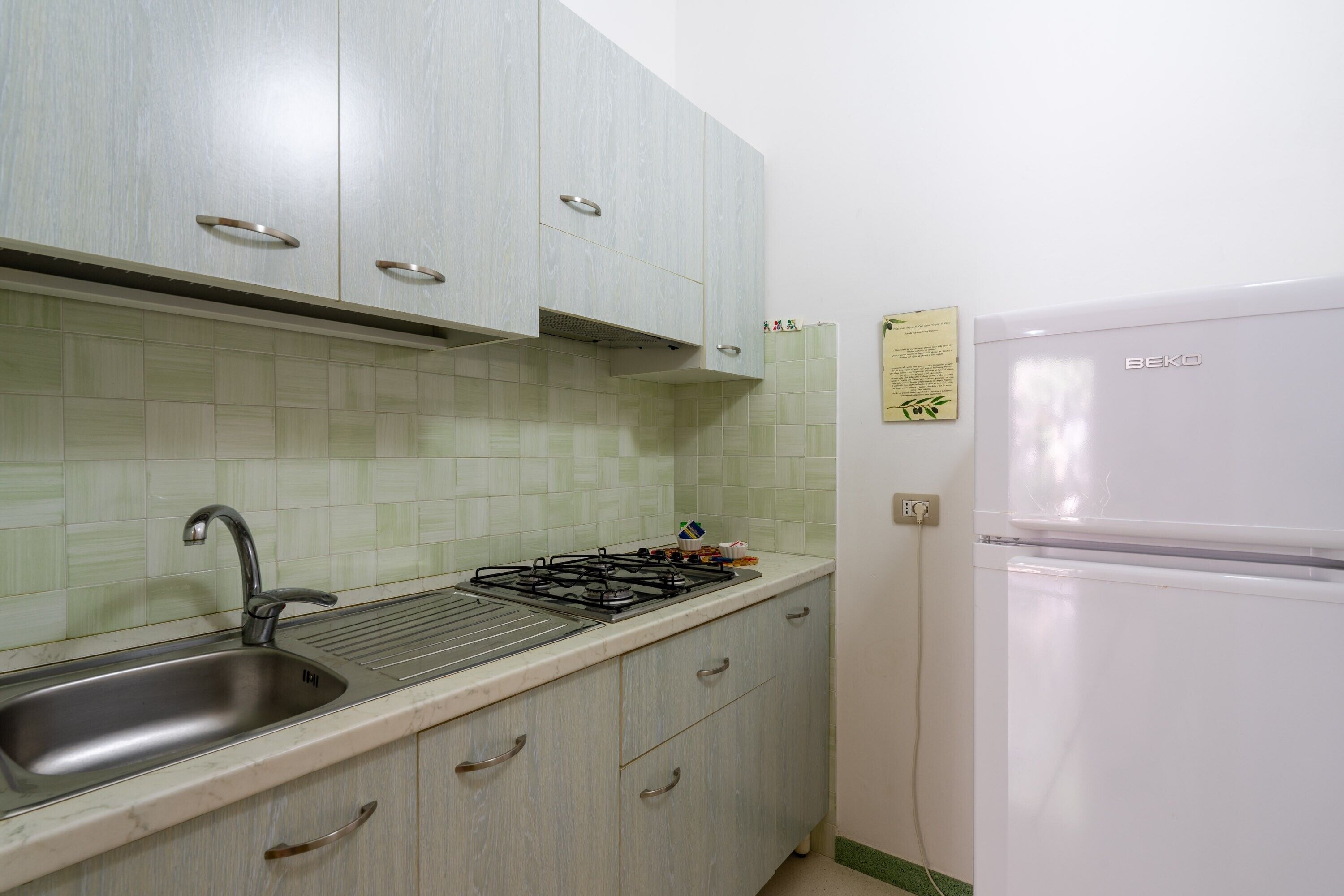 Fridge, stovetop, high chair, cookware/dishes/utensils