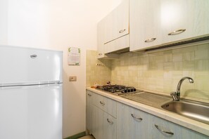 Fridge, stovetop, high chair, cookware/dishes/utensils