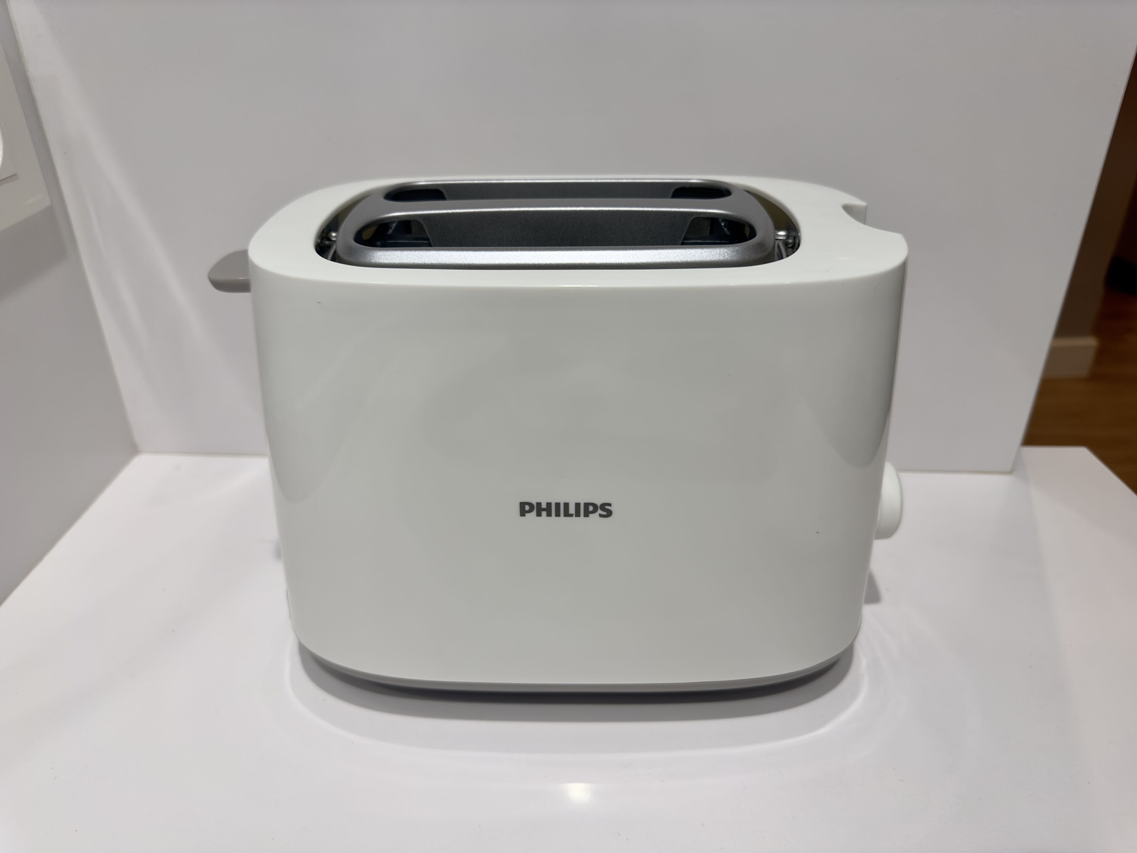 A white Philips toaster on a white surface.