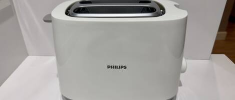 A white Philips toaster on a white surface.
