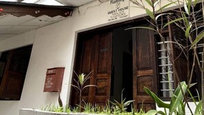 A building with a sign indicating it is a guest house named 'Flamingo'. - Flamingo Guest House (Zanzibar Town)
