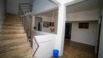 A staircase with metal railings leading to a landing.