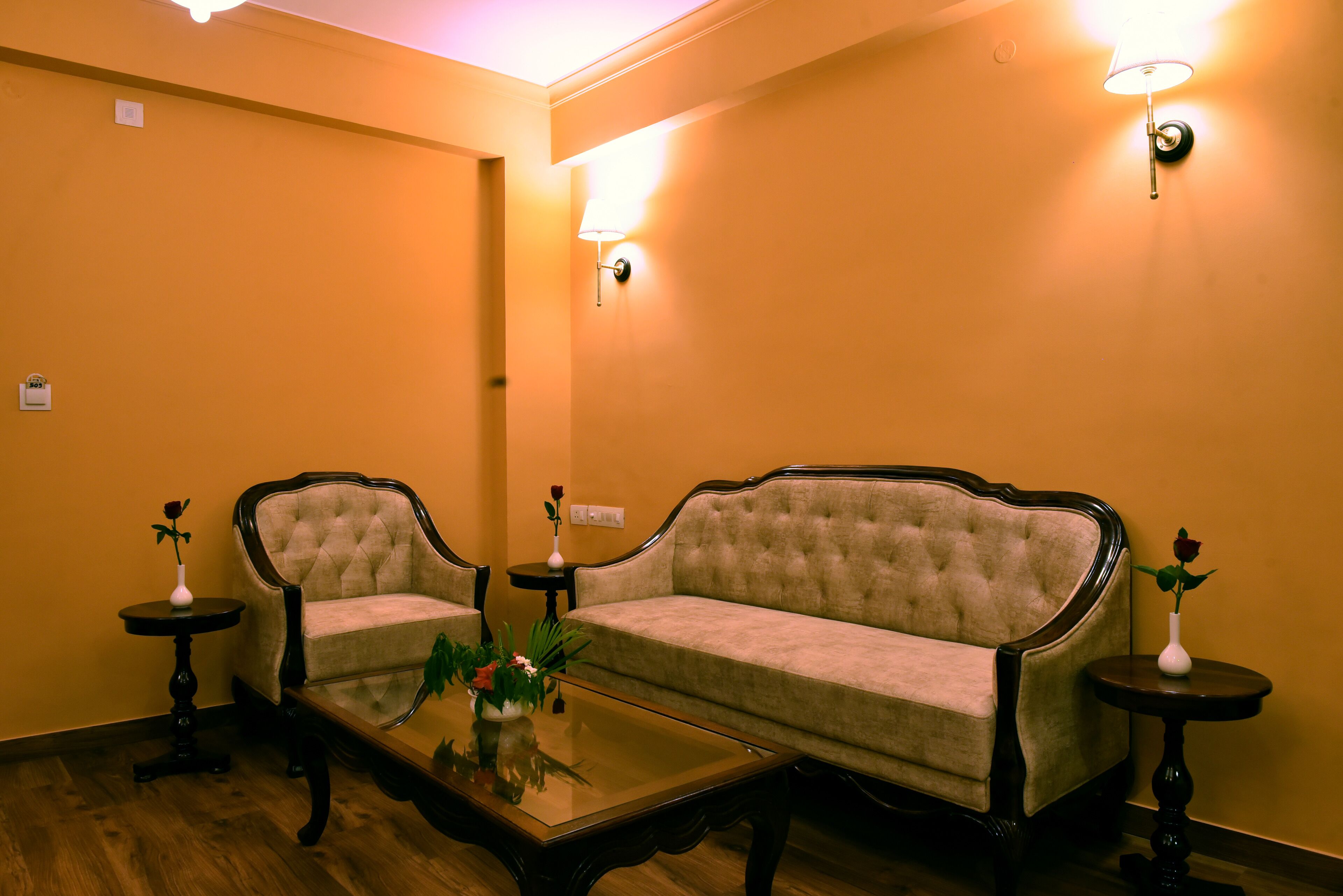 A room with a sofa, two side tables, and a coffee table.