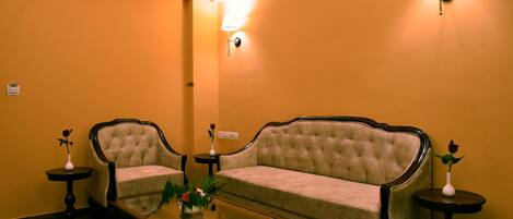 A room with a sofa, two side tables, and a coffee table.