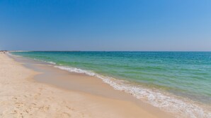 Una spiaggia con acque cristalline e una riva sabbiosa.