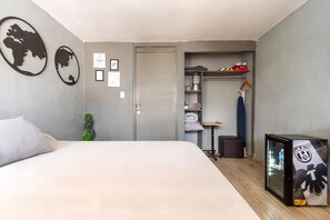 A modern bedroom with a bed, a wardrobe, and a small desk area. - Agua Azul by tuhost (Guadalupe)