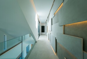 A modern hallway with glass railings, recessed lighting, and a clean, minimalist design. - Villa Nordic Star Seaview Near Kata Beach (Muang)