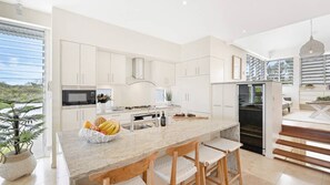 Fridge, stovetop, dishwasher, coffee/tea maker