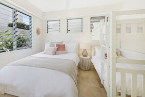 A bedroom with a bed, bedside table, lamp, and a bunk bed. - Soul on Sunshine - Divine Sunshine Beach villa (Sunshine Beach)