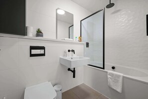 Bathtub, hair dryer, towels, soap