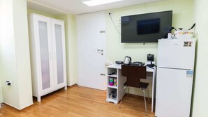 A compact kitchen with a refrigerator, a microwave, a coffee maker, and a small shelf with kitchenware. - Retire with Outstanding Lycabettus View (Athens)