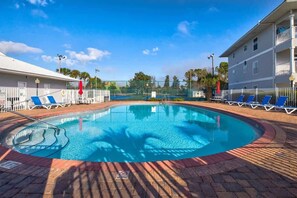 A swimming pool with lounge chairs, a no diving sign, and a building with balconies. - Walk to the beach-Community Pool/Seasonally Heated (Santa Rosa Beach)