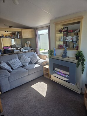 TV, fireplace - family holiday home. (Rhyl)