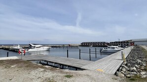 A marina with boats docked, a wooden pier, and a row of buildings in the background. - 2 Bed House Sleeps 4 With Garden & Free Parking (Ronneby)