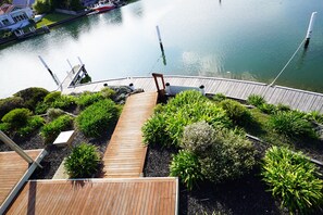 Enjoy serene views of the river from the dock and surrounding lush greenery.