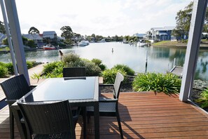 Enjoy al fresco dining on the riverside deck surrounded by lush greenery.