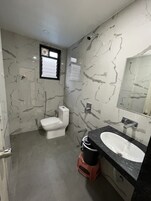 Casa de banho com sanita, lavatório e espelho.