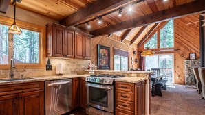 A kitchen with wooden cabinets, a stainless steel dishwasher, and an oven. - Sukoon Retreat - Free Summer Pool Access! (Dorrington)