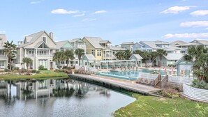 A waterfront property with multiple houses, a swimming pool, and a dock. - Stunning Lakeside Home near Keira’s Pool & More Cinnamon Shore Amenities. (Port Aransas)