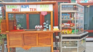 A food stall with a signboard listing items like 'KAMU MAU', 'KOPI TEH', and 'ATAU AKU'. - Hotel O Trisna Patihan Resort (Tulungagung)