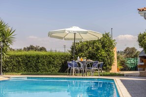 Relax by the serene pool surrounded by lush greenery and enjoy a refreshing swim.