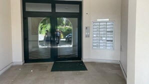 A hotel entrance with a glass door, a mail slot on the wall, and a tiled floor. - Diana apartment, near the historic center bright and spacious (Oderzo)