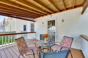 A covered porch with a wooden ceiling, a white exterior wall, and a glass table with chairs. - ~ 8 Mi From Canalside! Buffalo Vacation Rental (Buffalo)