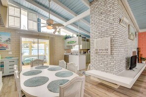Enjoy a spacious living area with a central dining space, kitchen, and seating area.
