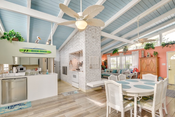 Enjoy meals in the spacious kitchen and dining area with a fireplace, microwave, and dining table.
