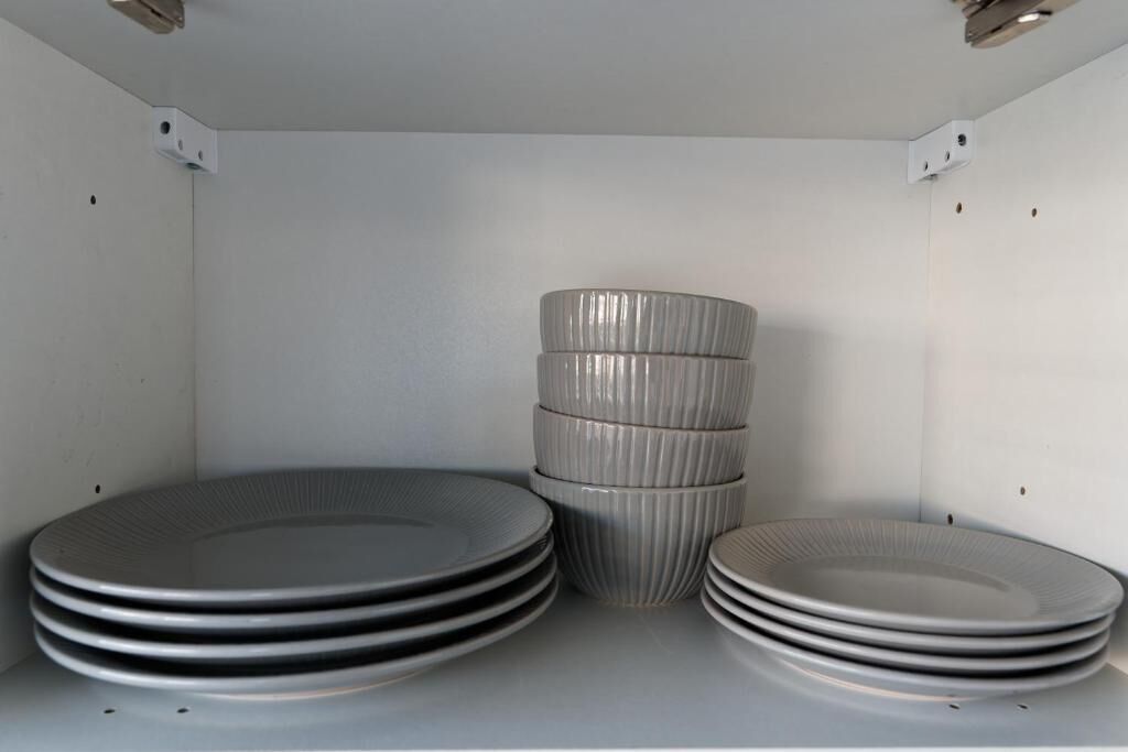 A storage area with neatly stacked plates and bowls.