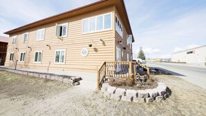 A two-story building with a flat roof and a front porch. - Rewak Studios: Gigabit Powered WiFi! Hotel-Style Furnished Studios--Easy Walk to Lots of Places (Fairbanks)