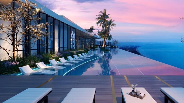 A modern infinity pool with lounge chairs, a wooden deck, and a view of the ocean at sunset. - The Song Vung Tau Apartment Cookies (Ho Chi Minh City)