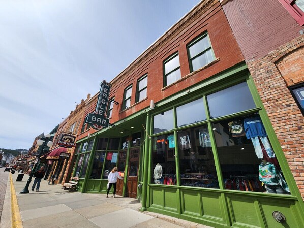 A storefront with large windows displaying merchandise.