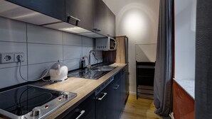 Une cuisine moderne équipée d’une cuisinière intégrée, d’un four à micro-ondes et d’un évier.