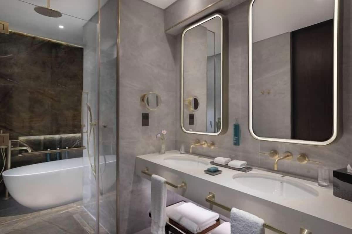 Bathroom | Separate bathtub and shower, free toiletries, hair dryer, slippers