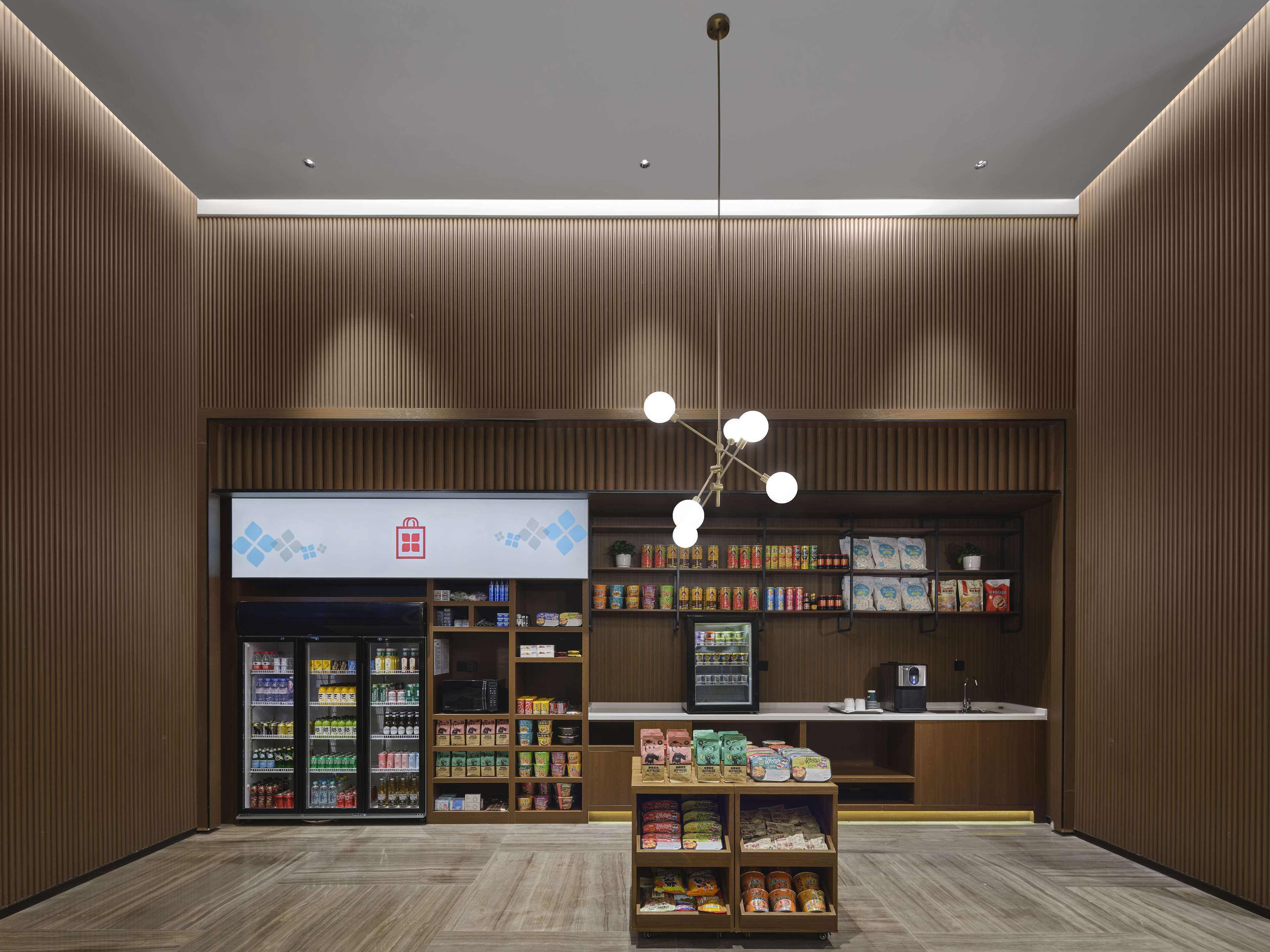A modern retail space with a variety of products, including beverages, snacks, and packaged goods.