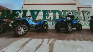 A building with the sign "REVEDEDE" and several ATVs parked in front. - BELVEDERE  (Baia de Fier)