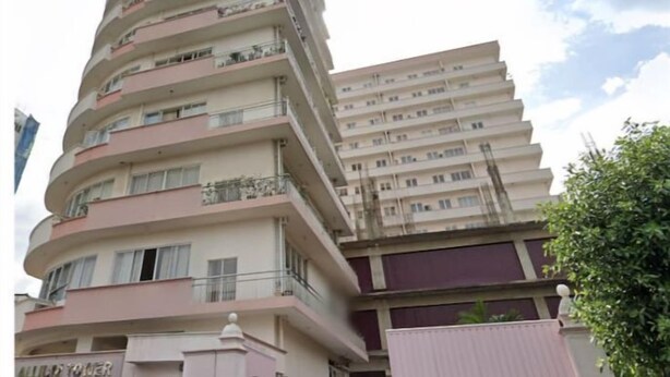 A multi-story building with a curved facade, balconies, and a sign reading "ALLP TOWER". - Newly Renovated Spacious 2 Bedroom Apartment (Colombo)