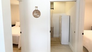 A hallway with a bed on the left, a door with a 'Get Cross' sign, and a closet on the right. - Cottage at Cave Run  (Salt Lick)