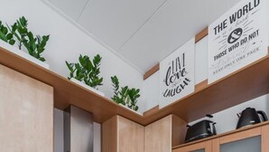 A modern kitchen with wooden cabinets, a stainless steel range hood, a built-in oven, a dishwasher, and a granite countertop. - Apartment & Studio Riva Lucija by Litto (Split)