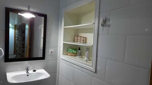 A bathroom with a white sink, a mirror, and a medicine cabinet. - Ca Bastiana (Sevares)