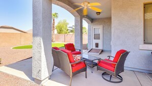 A covered patio with wicker furniture and a ceiling fan. - Near Parks & Golf: Maricopa Home w/ Covered Patio! (Maricopa)