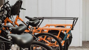 Bicycles parked in front of a white wall. - Manresa Surf House 1 bed upstairs unit #4 (La Selva Beach)