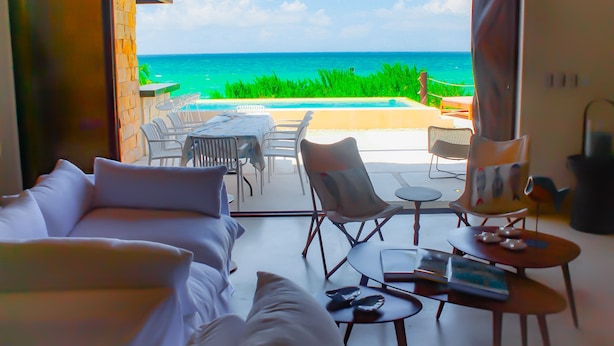 Ein Zimmer mit Meerblick, einem Pool und Sitzmöglichkeiten im Freien.